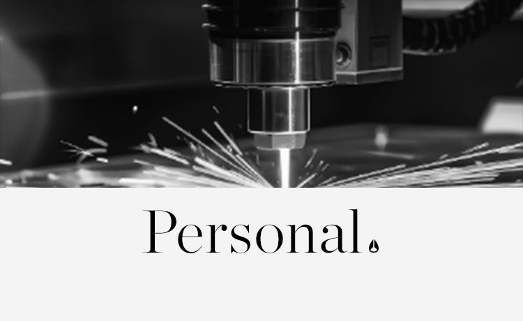 Black and white close-up of a laser engraving machine creating sparks, with the word "Personal." below.