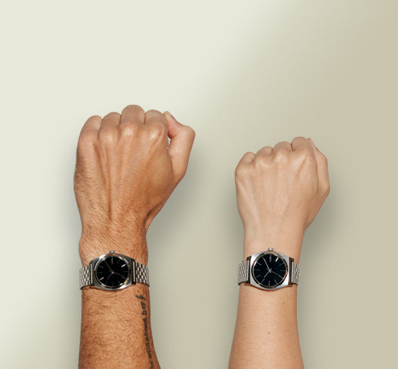 Hands wearing medium Nixon watches